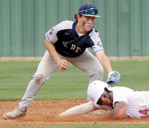 A Duncan base runner tries to slide under the tag of Dawson Davidson on a stolen base attempt