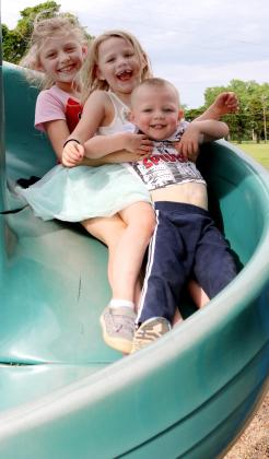 Three kids on slide