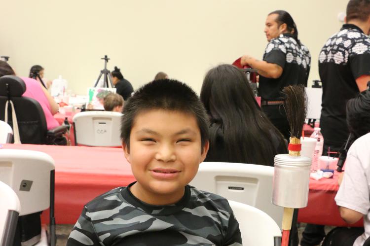 Christian Shorteeth, 10, makes a gourd