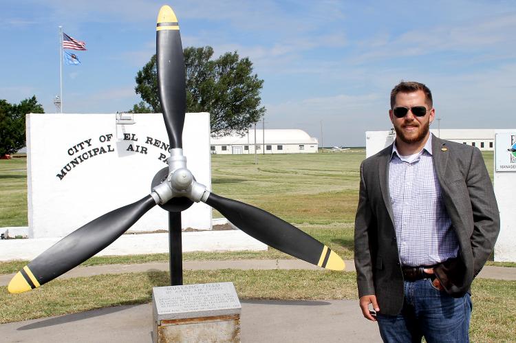 Adam Fox stands in front of the airport entrance