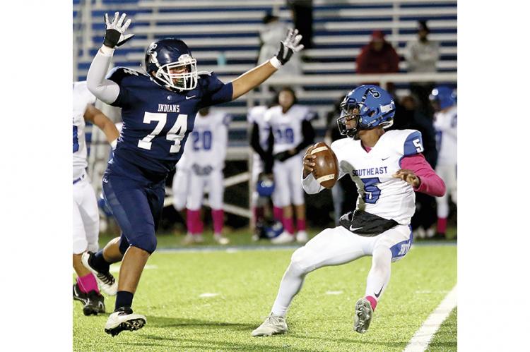 Alex Perdomo puts pressure on the quarterback from Southeast.