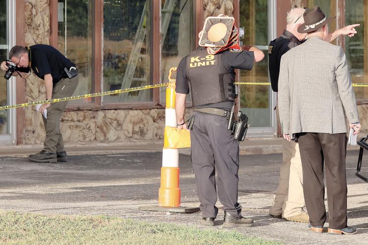 Kirk Dickerson (hat) listens to information being relayed while Capt. David Beaty takes a photo