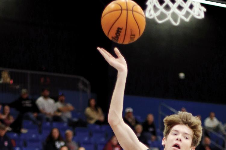 Hunter Arnold shoots the ball as he crashes into Tyler Norton