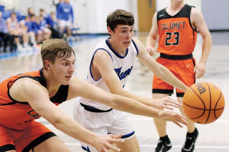 Calumet’s James Daughety and Union City’s Colson Combs battle for a loose ball