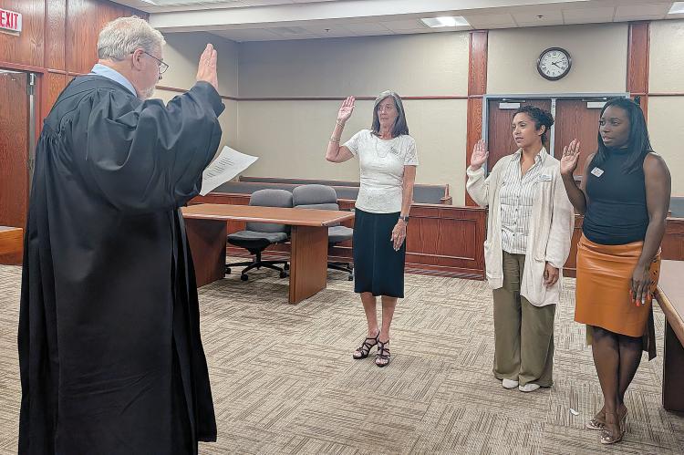 Judge Bob Hughey swears in three new CASA volunteers