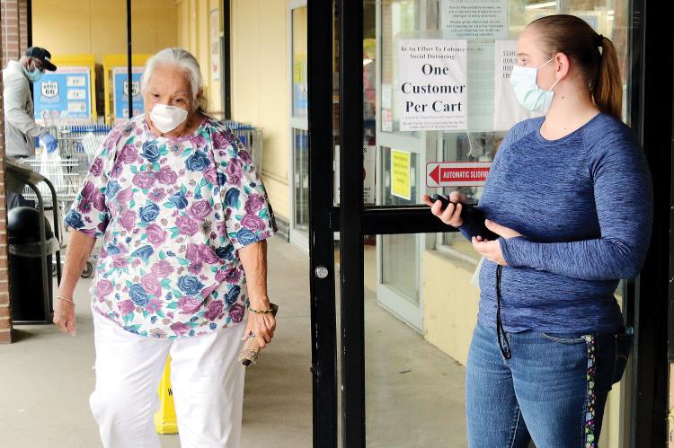 United Supermarket employee keeps track of the number of customers