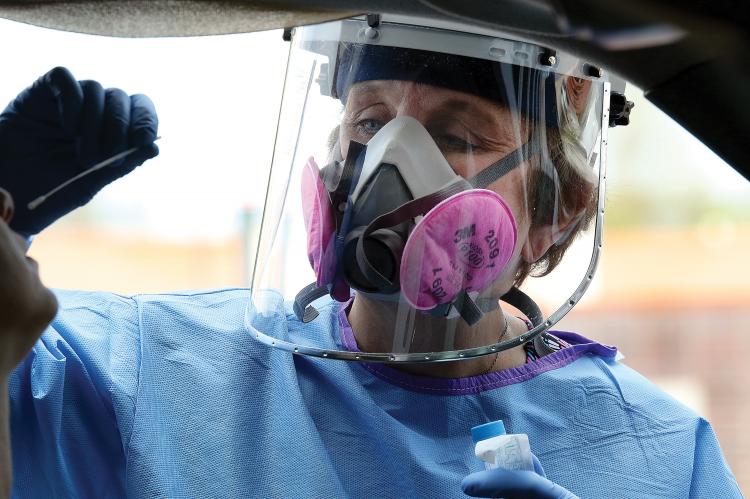 Canadian County Health Department nurse prepares to swab nostril