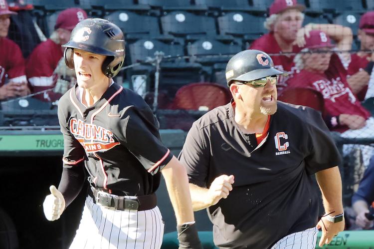 Cody Thiessen yells at a trailing base runner as his son, Konnor (left) scores