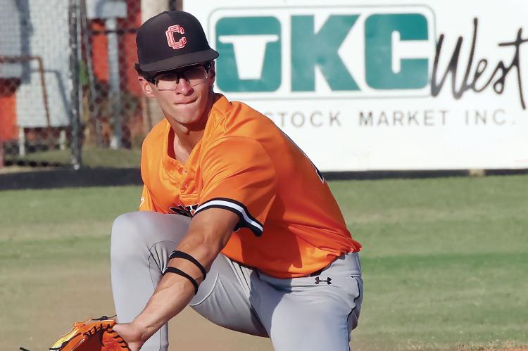 Brendon Voss kneels down to backhand a pickoff throw
