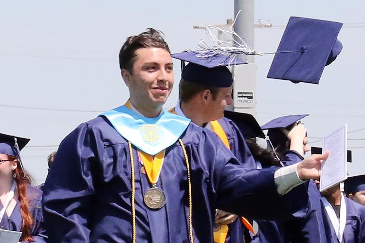 Christian Avalos tosses his cap into the air