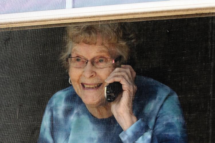 Constien looks through the window of her room
