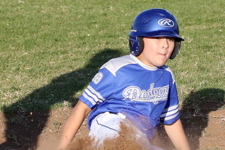 Aden Lanman slides into third base