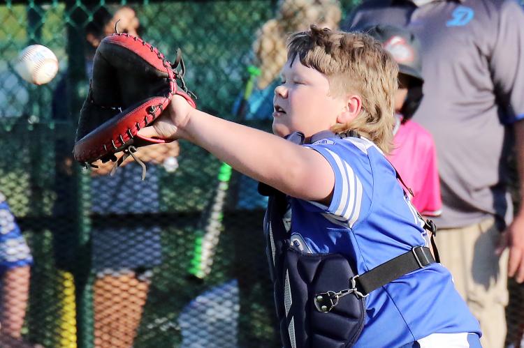 Jacob Wilson reaches up to snag a high throw to home