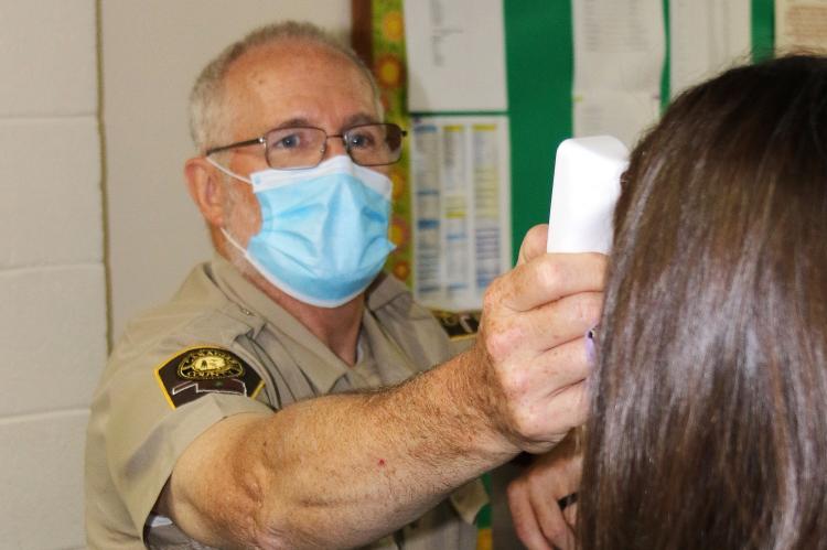 Canadian County Deputy Thomas Koch checks temperature