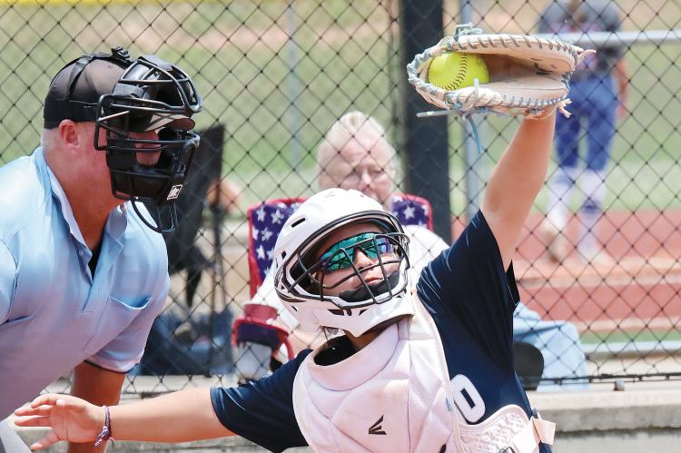 Kallie DeShields reaches up to snag a high pitch