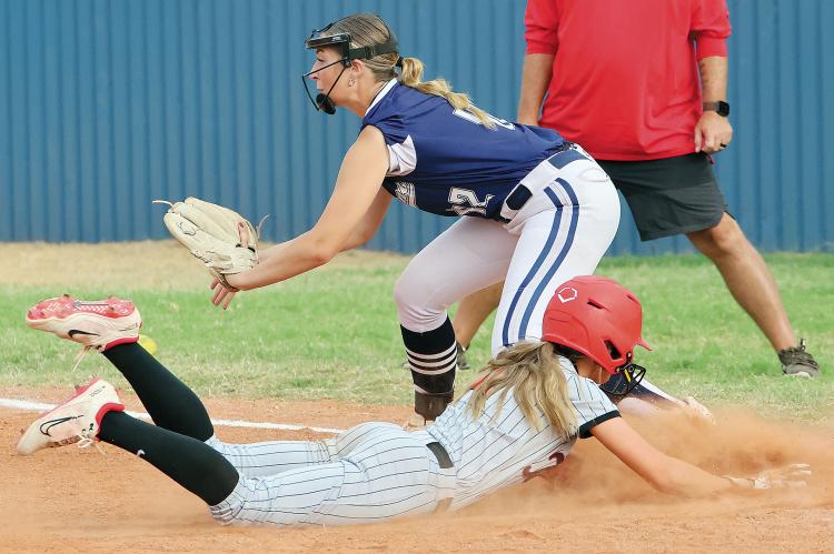 Alyssa Duran tries to block a pickoff throw to the bag