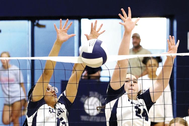 Qyra Jones (left) and Jewell Graham jump for a double block attempt