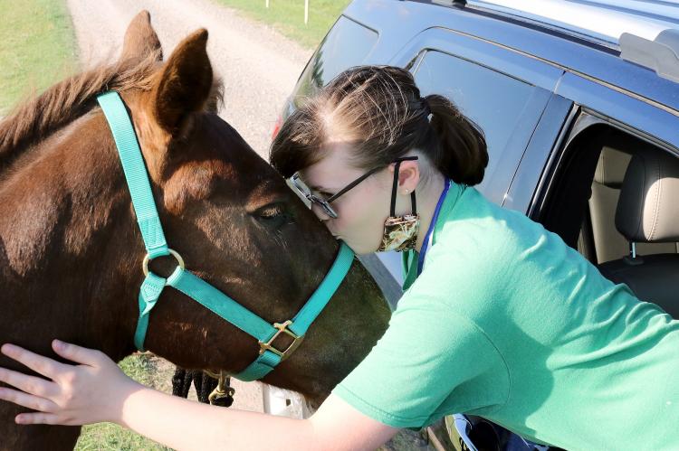 Hannah Wallace kisses Pollo on the forehead
