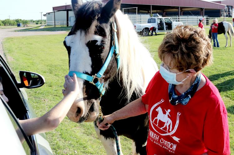 Humphreys holds Blue as a rider pets his nose