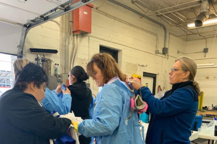 Workers and nurses suit up to start testing
