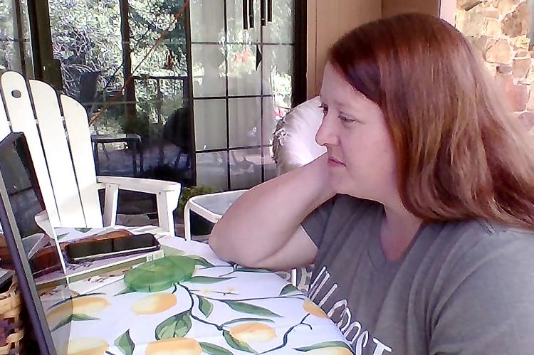 Sara Heasley uses the Internet from Mustang to conduct an online class