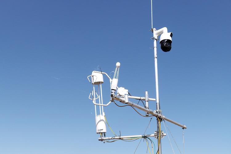 Randy Hawk points to the components of a Flux Tower