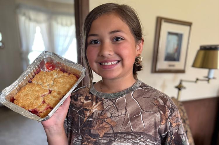Isabelle Pena proudly shows off the cobbler she made for Grandma