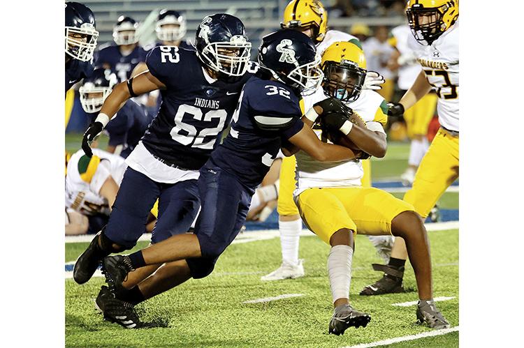 Marlon Whitlow (62) assists on a tackle in the game with Lawton MacArthur.
