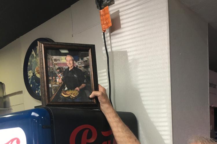 Marty Hall holds the framed photo Bill Edwards gave him