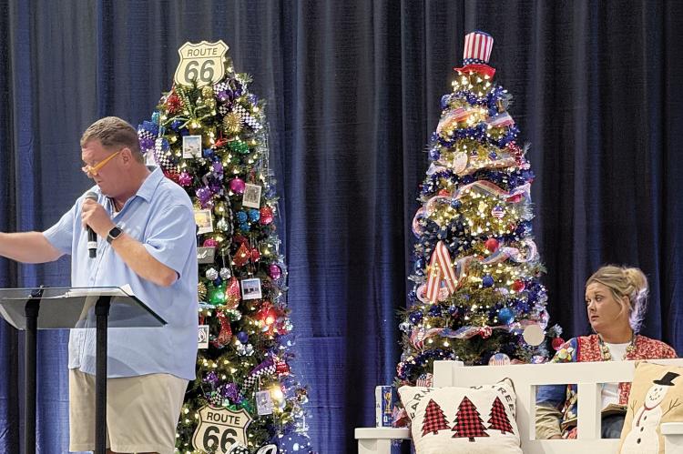 Matt White conducts the auction as Lindsey Vice assists
