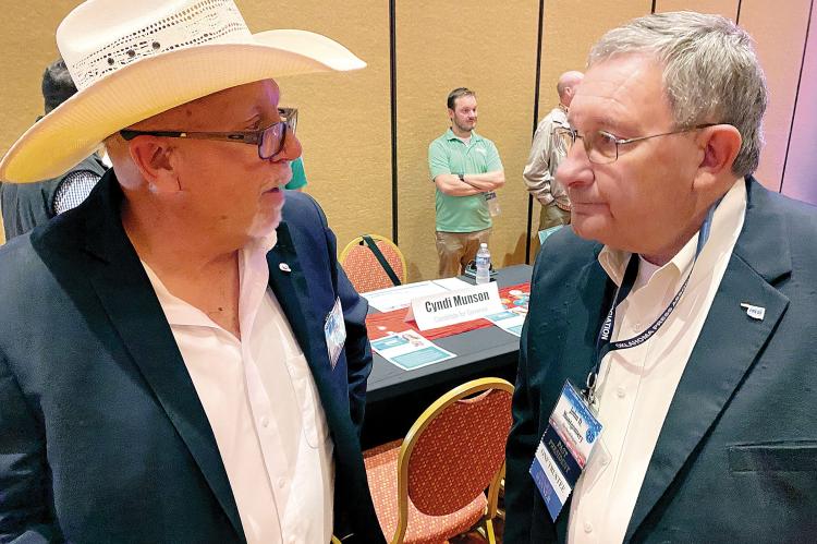 Craig McVay, left, visits with John D. Montgomery