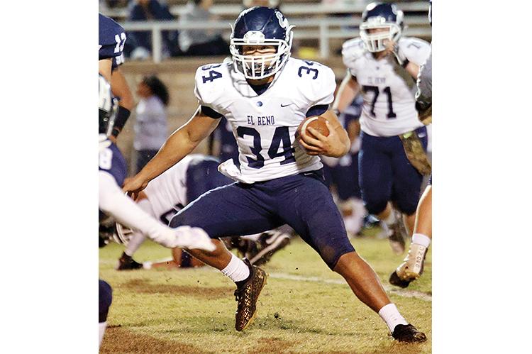 El Reno High School senior Mikey Devereaux carries the ball in the win over Altus.