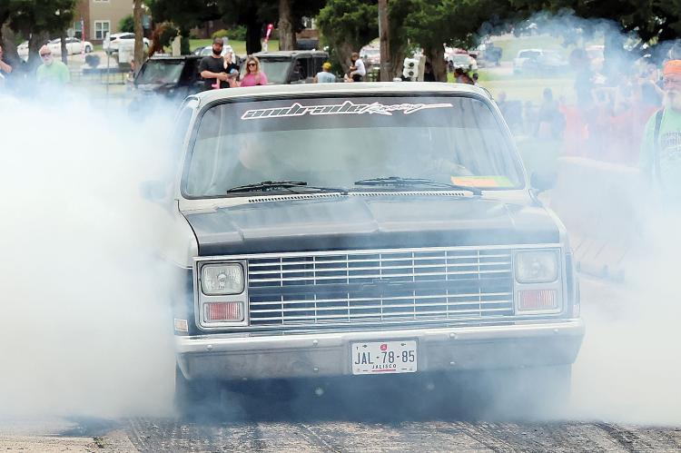 Kevin Watson (orange cap) watches this pickup churn out the smoke