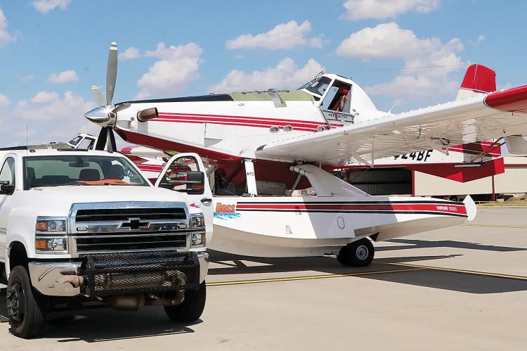 The fuel tanker at El Reno Regional Airport pulls up next to one of the firefighting planes