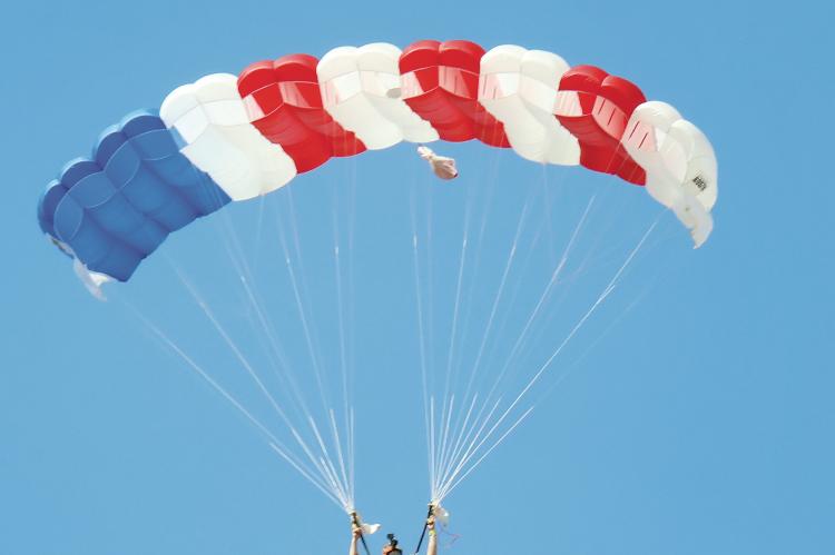 A member of Skydive AirTight carries the American flag