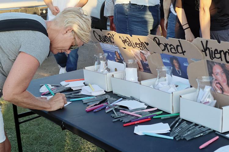Kandy Conner writes a note to each of the teens