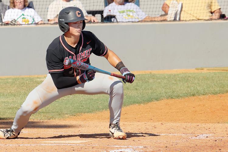 Wyatt Cox drops down a bunt
