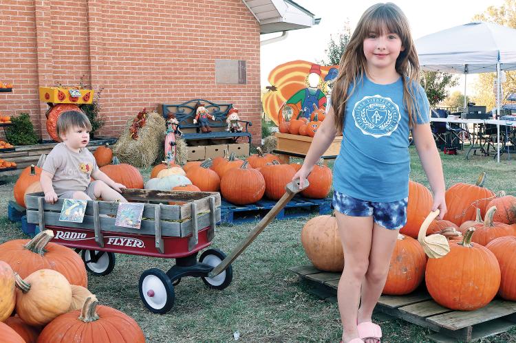 Aria Hensley pulls Bode Hensley through the rows of pumpkins