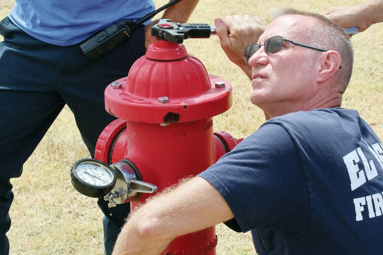 Jason Duff checks pressure on a different hydrant