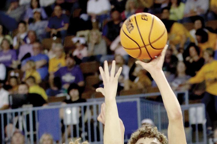 Jett Mueggenborg shoots a jumper off a Caddo defender