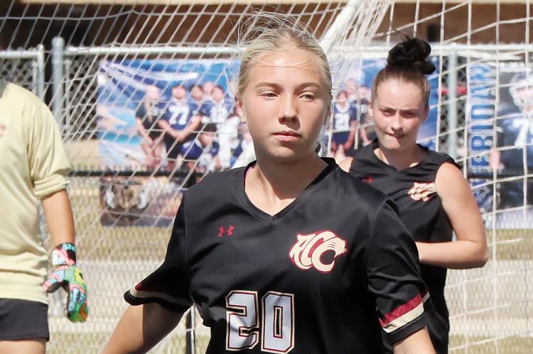 Haven Fleenor chases down a loose ball in front of the Cougars net