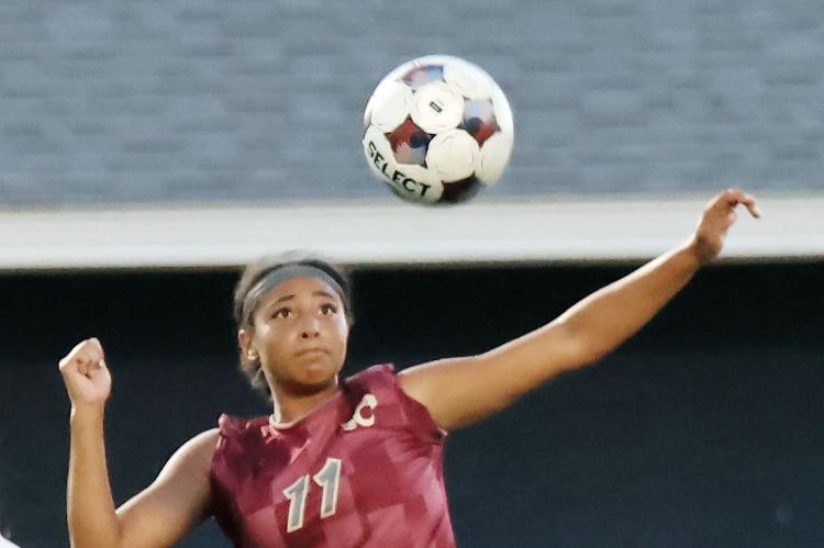 Makynzi Spencer-Friday tries to clear out a ball from the Cougars end of the field