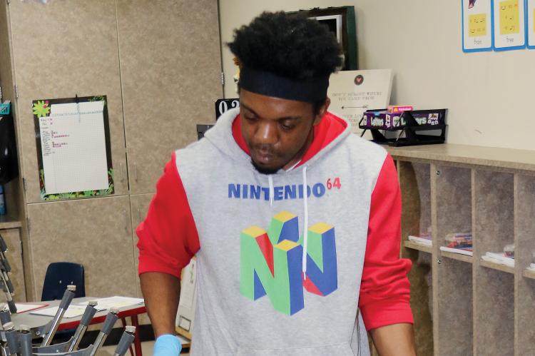 ERPS custodian Hayes sprays down a table