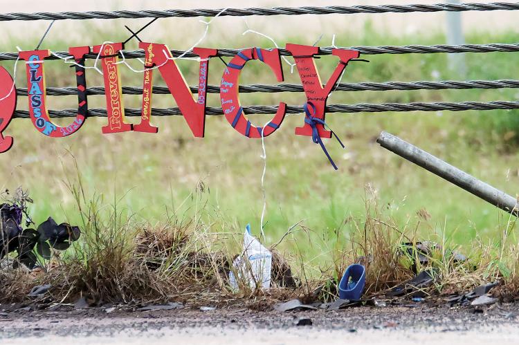 A memorial for El Reno’s Quincy Jones is hung from the cable barrier near the crash site