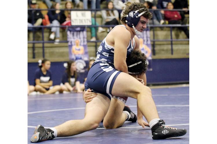 Spencer Davidson, below, tries to fight off a shot by Perry’s Caleb Owen.