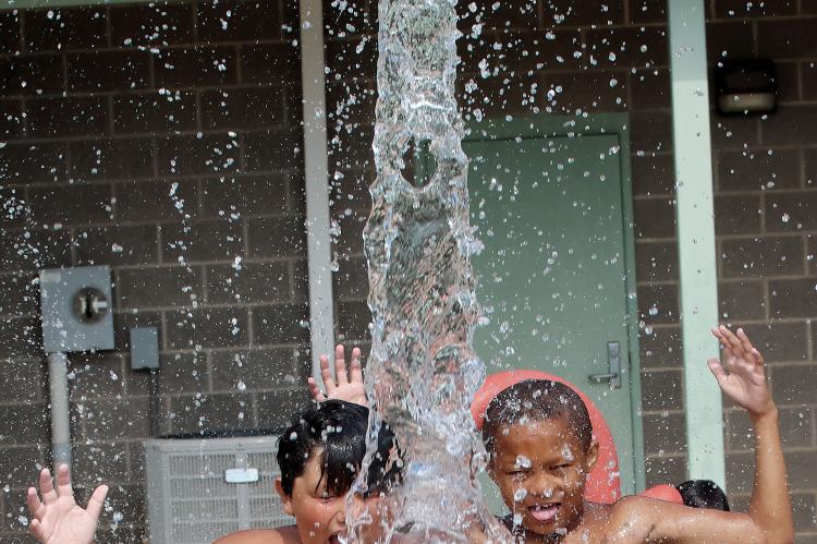 J.R. Chavez and Carl Richey react to a bucket of cold water being poured on their heads