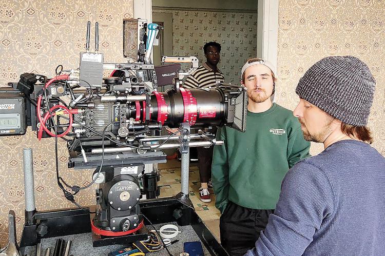 Gared Reinike (left) discusses an angle with a crew member during filming