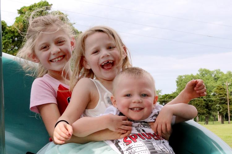 Three kids on slide