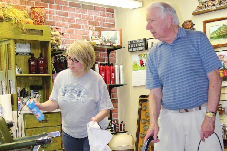 Joe Howarton vacuums the floor at Royal Razor