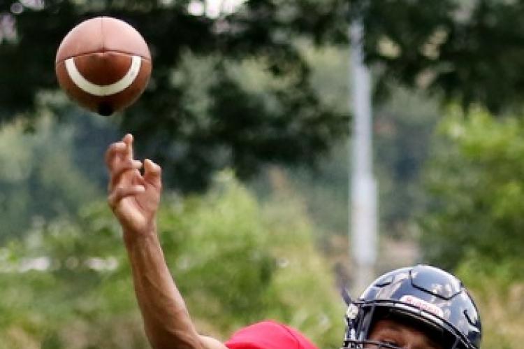 Quarterback Dorian Plumley throws a pass during EHS’ first day in pads.